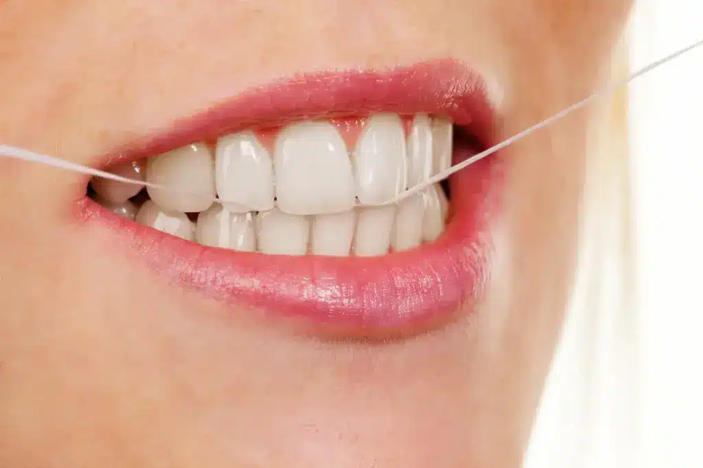 Woman Uses Dental Floss The History Of Dental Floss