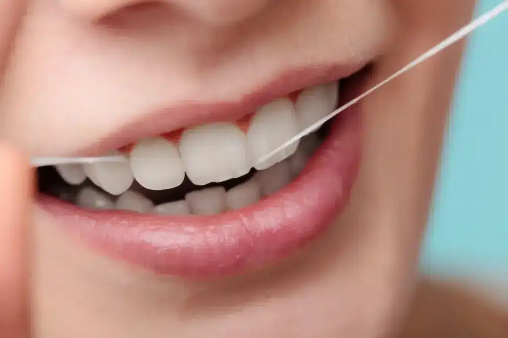 Woman Smiling with Dental Floss 