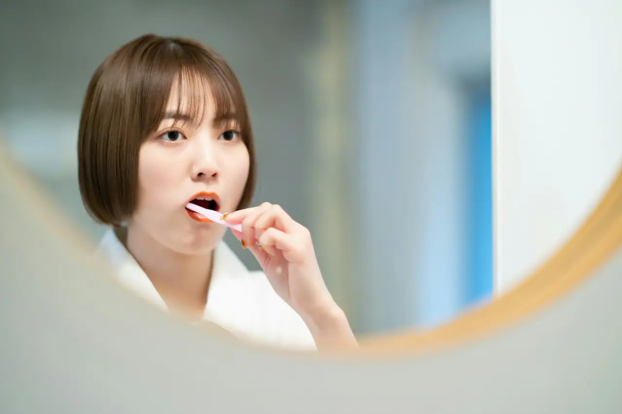 How Are Oral Health and Heart Health Related? Woman Brushing Her Teeth