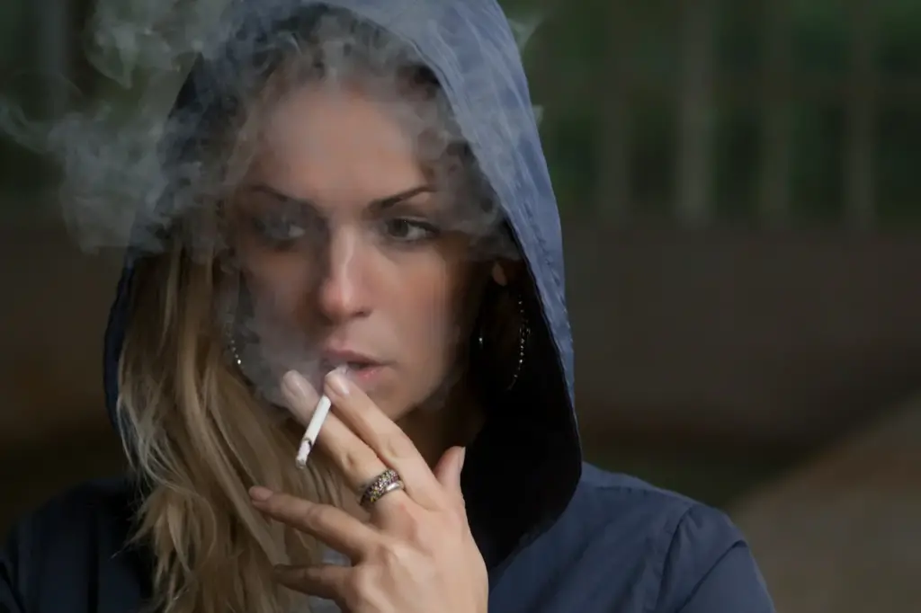 Woman In Hoodie Smoking Cigarette